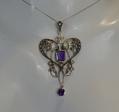 A very pretty 9ct solid gold lavalier pendant set with a central square cut amethyst surrounded in an open work seed pearl set frame. the bale also set with seed pearls. measures 4.8cm high x 2.8cm wide. stamped 9ct to back. in excellent condition.comes on 18 inch `9ct gold chain. Art Nouveau Purple Jewelry For Gift, Purple Art Nouveau Jewelry For Gift, Purple Art Nouveau Jewelry Gift, Purple Art Deco Necklace For Gift, Central Square, Pearl Set, Seed Pearl, Square Cut, Pendant Set