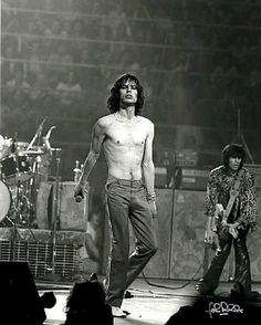 the rolling stones performing on stage in front of an audience