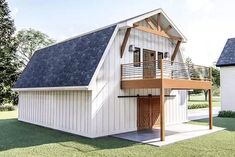 a two story white barn with a loft