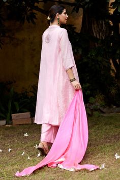 Baby pink three fourth sleeves straight kurta with floral embroidery on the placket and floral butta at the back. Paired with matching broad pant, bright pink tabby silk silver lumpi border dupatta and an inner.
Components: 4
Pattern: Embroidery
Type Of Work: Floral
Neckline: Mandarin Collar
Sleeve Type: Three Fourth
Fabric: Pure Chanderi, Tabby Silk 
Color: Pink
Other Details: 
Weight: 700gms
Length:
Kurta: 45inches
Sleeves: 17inches
Pant: 40inches
Model Height: 5ft 8inches, wearing size S
Note Festive 3/4 Sleeve Sets, Pink Floral Embroidery Cotton Silk Sets, Elegant Pink Cotton Palazzo Set, Spring Pink Cotton Silk Sets, Resham Embroidery Kurta With 3/4 Sleeve, Festive Pink Set With Set-in Sleeves, Pink Traditional Wear For Spring With Traditional Drape, Spring Cotton Silk Sets With Embroidered Border, Pink Traditional Drape Wear For Spring