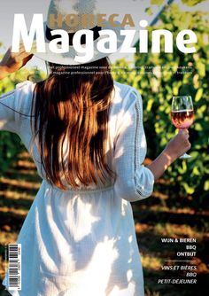 a woman holding a glass of wine on the cover of magazine magazine,