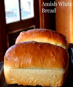 two loafs of bread sitting on top of a table next to each other with the words amish white bread recipe