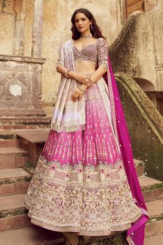 Magenta silk lehenga with heavy embroidery in pearl, cutdana and sequin and attached cancan. Paired with an embroidered padded blouse, a light purple heavily embroidered dupatta with tassels and a magenta embroidered dupatta with a delicate border.
Components: 4
Pattern: Embroidered
Type Of Work: Cutdana, Pearl, Tikki
Neckline: Sweetheart
Sleeve Type: Elbow
Fabric: Silk, Organza
Color: Magenta
Other Details: 
Attached lining
Padded blouse
Approx. product weight: 5 kgs
Lehenga length: 44 inches
O Meenakari Raw Silk Choli For Saree, Reception Meenakari Dola Silk Choli, Bollywood Style Meenakari Raw Silk Sharara, Anarkali Choli With Meenakari On Dola Silk, Bollywood Meenakari Lehenga For Reception, Bollywood Style Raw Silk Sharara With Meenakari, Bollywood Style Meenakari Lehenga For Reception, Anarkali Choli In Dola Silk With Meenakari, Meenakari Saree Set For Reception