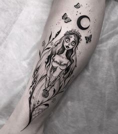 a woman's leg with a black and white tattoo design on the left thigh