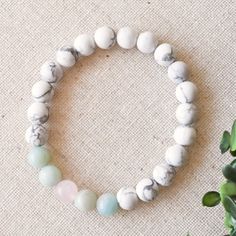 Release, breathe and smile as you wear this calming unicorn crystal bracelet. This healing crystal bracelet integrates white howlite, amazonite, and rose quartz to increase your own calming, self-love vibes while also increasing your mindfulness to maintain this state. We handcraft each natural crystal bracelet using a meditative mala design to let you chill and play with the beads as you wear your special bracelet. The calming unicorn bracelet is completed with reiki vibes and tons of care to h White Rose Quartz Beaded Bracelets With 8mm Beads, White Rose Quartz Beaded Bracelets For Healing, White Rose Quartz Beaded Bracelet With 8mm Beads, White Rose Quartz Healing Beaded Bracelets, White Rose Quartz Jewelry With 8mm Beads, White Rose Quartz Crystal Bracelet With Gemstone Beads, White Rose Quartz Bracelets With Round Beads, Adjustable White Rose Quartz Beaded Bracelets, White Rose Quartz Bracelets With 8mm Beads