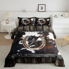 a bed with a cow print comforter and pillows