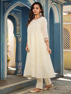 This is a beautiful two piece set. It comes with embroidery detailing anarkali style kurta has round neck; 3/4th sleeves & calf length teamed with solid trouser pants. Total No of Set-2 Fabric: Cotton Work Done - Embroidery detailing. Kurta Length-Calf Length Sleeve Length: 3/4th Sleeves Neck: Round Neck Style: Anarkali Color: White Occasion: Party Wear Washing Instructions: Hand Wash or Dry Clean Cotton Ankle-length Kurta For Eid, Spring Anarkali Set With Dabka Work, Spring Anarkali Churidar With Dabka Work, Cotton Churidar For Eid, Cotton Churidar For Eid, Ankle-length, Cotton Ankle-length Churidar For Eid, Designer Ankle-length Cotton Kurta, Festive Embroidered Ankle-length Kurta, Bollywood Style Churidar With Embroidered Border For Spring