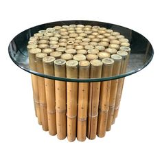 a glass table topped with lots of bamboo sticks