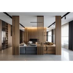 a living room filled with furniture and tall wooden pillars in the middle of it's walls