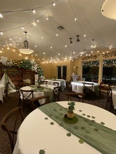 the dining room is decorated for christmas with lights strung from the ceiling and decorations on the tables