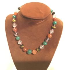 Here is a unique multicolored Gemstone Graduated Beaded Necklace that was purchased in 1972 from a high end specialty gift shop. These beautifully graduated beads feature Green Jade (old), Tiger Eye, Carnelian and Crystal Rose Quartz and are each hand knotted with Silk thread. The closure is a Stamped Silver antique Filigree slide in Clasp. There are 33 beads ranging in size from the large center Jade bead that's over 5/8" diameter to the smallest 3/8" diameter - most in the ½" size rangetotal weight over 76 grams. Excellent condition My items are mostly vintage, and with vintage comes a previous life. I examine items carefully, but minor wear can be expected. I will note anything I find beyond minor. I try to show condition as well through photos, so please look carefully. I'm happy to an Adjustable Multicolor Crystal Necklaces With Large Beads, Adjustable Multicolor Crystal Necklace With Large Beads, Multicolor Crystal Necklace With Large Round Beads, Multicolor Agate Beaded Necklaces, Multicolor Beaded Agate Necklaces, Multicolor Agate Gemstone Bead Necklaces, Multicolor Agate Large Beaded Necklaces, Multicolor Agate Beaded Necklace With Large Beads, Multicolor Agate Necklaces With Colorful Beads