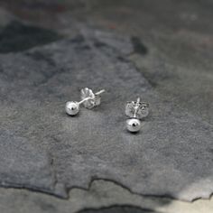 Solid Sterling Silver Studs I melted sterling silver into tiny round balls. The the balls are soldered on to sterling silver posts with floral western style earring backs. 3.5mm balls ~ perfect to wear alone or for second piercings. For more earrings: https://www.etsy.com/shop/KiraFerrer?section_id=7937255&ref=shopsection_leftnav_3 To see my entire collection: https://www.etsy.com/shop/KiraFerrer?ref=hdr_shop_menu Dainty Silver Earrings With Round Beads, Second Piercings, Second Piercing, Tiny Studs, Sterling Silver Stud Earrings, Tiny Stud Earrings, Silver Stud Earrings, Dainty Earrings, Sterling Silver Studs