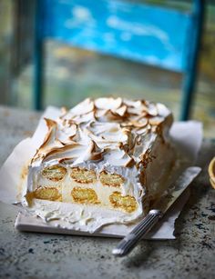 a piece of cake sitting on top of a white plate next to a knife and fork