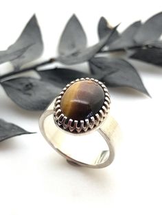 A Lovely Vintage Sterling Silver & Tigers Eye Stone Ring.  A beautiful ring, with a oval Tigers Eye Stone set in a claw setting.  The ring and stone are in perfect condition.  There is a full British Hallmark, London 1975 with the makers mark BL.  The ring is a UK Size M, USA Size 6, EU Size 52. Brown Oval Gemstone Jewelry, Classic Oval Brown Ring, Classic Brown Oval Ring, Oval Brown Jewelry For Anniversary, Brown Oval Gemstone Rings, Brown Oval Jewelry For Anniversary, Sterling Silver Ring With Large Oval Stone, Oval Sterling Silver Ring With Large Stone, Oval Sterling Silver Rings With Large Stone