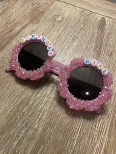 Personalized birthday girl sunglasses! Personalized sunglasses, made to order. Perfect for a birthday party to be used as favors or as a gift for a little girl! Fit best on children ages 2-12.  Each order comes with a sunglass sleeve. Each pair will include pink Sparkles. Please send a note if you would like personalization to be arranged a certain way, otherwise all glasses will vary slightly as glitter lays down.  You can choose from a variety of glasses colors with the pink glitter if you DM Girl Sunglasses, Personalized Sunglasses, Pink Sparkles, Glitter Birthday, Girl With Sunglasses, Birthday Girl, Pink Glitter, Personalized Birthday, Eyewear Sunglasses