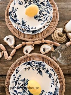 two blue and white plates sitting on top of a wooden table