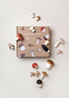 an assortment of mushrooms are scattered around the box