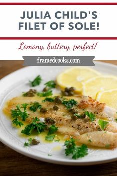 a white plate topped with fish and lemon slices