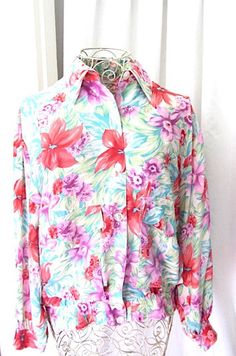 Woman's 80s summer silk blouse/jacket. Pale green with pink and lilac flowers and turquoise leaves. Nordstrom, Town Square. L. Chest. 50 inches length from back of neck to hem 27 inches Button cuffs. Lightly elasticated bottom. 7 front buttons. 2 large front pockets. 100% Silk. 80s Summer, Jacket Summer, Silk Jacket, Vintage Silk, Boho Clothing, Silk Blouse, Vintage Tops, Boho Outfits, Vintage Floral