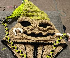 a crocheted star wars mask is laying on top of a piece of fabric