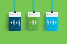 three luggage tags with blue and green designs on them, hanging from strings against a green background