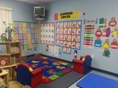 a child's playroom with toys, bookshelves and pictures on the wall