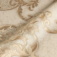 an image of a gold and white wallpaper with intricate designs on it's surface