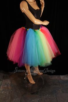 "Perfect tutu for Pride! This tulle tutu skirt Can also be used for carnivals, weddings, costumes, clowns, or anything rainbow themed! This tutu design is extra fluffy! This rainbow tutu design is Handmade from 50yards, two layers of gathered panels of soft smooth red, orange, yellow, mint, green, turquoise, purple, fuchsia and hot pink Bridal tulle. All tulle panels have been tightly machine gathered and serged to the soft rainbow fabric covered elastic waistband. This tutu is fully sewn not ti Fitted Tutu Dress For Carnival Costume Party, Spring Costume Party Tutu Dress With Tulle Skirt, Fitted Tutu Dress For Costume Party And Carnival, Carnival Costume Party Fitted Tutu Dress, Multicolor Tulle Tutu Dress For Costume Party, Stretch Tulle Tutu Dress For Costume Party, Fitted Tutu Dress With Attached Cancan For Costume Party, Multicolor Tulle Tutu Dress For Wedding, Fitted Tutu Dress For Summer Costume