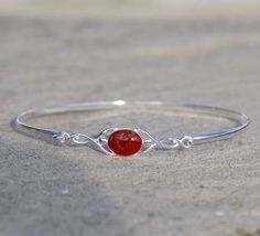 Celtic style bracelet in sterling silver or 9ct yellow, white or rose gold.Cremation ashes in Enigma Crystal Ruby, Sapphire, Emerald, Amethyst, Turquoise or Rose Quartz in 8mm by 6mm oval setting.Ruby shown, please see the colours page on my website for further options https://enigmahorsehairjewellery.co.uk/cremation-ash-jewelleryGold is hallmarked. Ashes Jewelry Cremation, Oval Setting, 7 Jewelry, Memorial Bracelet, Celtic Style, Ashes Jewelry, Cremation Ashes, Ruby Sapphire, Cremation Jewelry