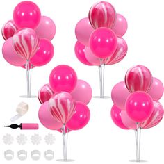 pink and white balloons are in the shape of hearts on sticks with markers, pens, and glue