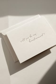 two white envelopes with writing on them