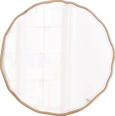 a round mirror sitting on top of a white wall