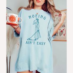 🩴  Victorian Design Hoeing Ain't Easy Shirt. Humorous Gardening T-Shirt. Gardener Gift. 🩴 Click here to view our shop for more great designs --- https://www.etsy.com/shop/GraceAndFlipFlops Click on the ❤️ to see our new designs as they arrive. 🩴 Comfort Colors T-Shirts - Made with 100% ring-spun cotton. The soft-washed, garment-dyed fabric brings extra coziness to your wardrobe while the Unisex relaxed fit makes it an excellent daily choice. The double-needle stitching throughout the tee make Relaxed Fit Shirt With Graphic Print For Gardening, Relaxed Fit Graphic Print Shirt For Gardening, Crew Neck Cotton Shirt For Gardening, Summer Cotton Shirt For Gardening, Cotton Shirt For Gardening In Summer, Casual Short Sleeve Gardening Shirt, Casual Short Sleeve Shirt For Gardening, Casual Cotton Shirt For Gardening, Gardening Shirts Funny