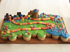 a birthday cake made to look like a train track with lots of candy on it