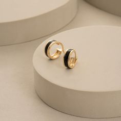 Introducing our 14K Solid Gold Hoop Earrings for Men, a blend of style and craftsmanship. These 10mm thick enamel huggie sleeper earrings are meticulously handcrafted, offering a delicate yet bold choice in men's jewelry. Whether it's for an anniversary or simply to elevate your everyday look, these dainty hoops make for a thoughtful and timeless gift. -- ⋆ This product is designed with Runda's fine handcrafting with sustainable methods. ⋆ Express-insured shipping to the whole world and delivery to cargo in only 3 business days. ⋆ Free return and warranty Product Details * 14K Real Solid Gold * Latch Back Closure * Single & Pair Available * Yellow - White - Rose Gold Available * Hypoallergenic * Model No RNDMN-X0E194068-C16 -- ♻️ UPCYCLING THE FUTURE A more sustainable future is determined Black Enamel Hoop Earrings For Gift, Black Enamel Hoop Earrings As Gift, Luxury Black Hoop Jewelry, Classic Small Hoop Earrings In Black, Classic Small Black Hoop Earrings, Small Black Classic Hoop Earrings, Gold Hoop Earrings With Black Enamel For Gift, Black Enamel Hoop Earrings, Gold Minimalist Earrings With Black Enamel