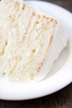 a slice of white cake sitting on top of a white plate