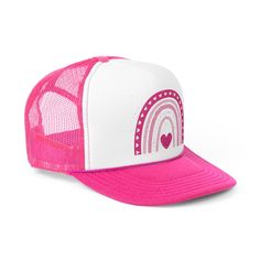 a pink and white trucker hat with a heart on the front, rainbows in the background