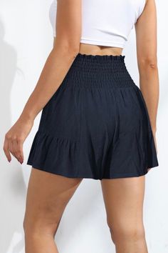 Love skirts but need the comfort and freedom of shorts? Then say hello to the Sawyer Swing Shorts featuring a unique, skirt-like silhouette with a playful ruffle hem and stretchy smocked waist & front tie. These shorts are truly the best of both worlds giving us the freedom & comfort of shorts while maintaining the flirty feminine vibe of a skirt. So go ahead, make a statement in these fun and flirty bottoms. Features: Stretchy Smocked Waist, Ruffle hemline, Front Waist Tie Material composition: Summer Skirted Bottoms With Built-in Shorts, Stretch Solid Color Bottoms For Vacation, Vacation Mini Skirt With Built-in Shorts, Stretch Bottoms For Vacation In Solid Color, Vacation Bottoms With Stretch And Solid Color, Vacation Bottoms With Stretch In Solid Color, Vacation Stretch Bottoms In Solid Color, Day Out Tiered Ruffle Shorts, Chic Gathered Short Skirt Bottoms