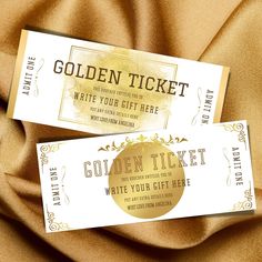 two golden ticket cards sitting on top of a brown satin material covered tablecloth,