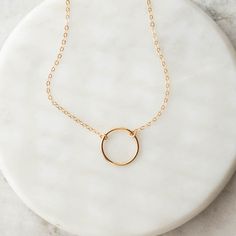 Our Essie Circle Necklace is a piece of timeless jewelry you will reach for over and over again. Featuring an effortlessly light and beautiful 14k gold filled open circle, this minimal design is perfect for everyday wear. Layer it with other necklaces or wear it alone. Details: Material: 14k gold filled or sterling sil Tagua Jewelry, Jobs For Women, Leather Store, Gold Necklaces, Tiny Heart, Circle Necklace, Timeless Jewelry, Brass Jewelry, Polish Jewelry