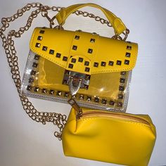 Bright Mustard Yellow Handbag With Gold Accents. Half Bag Is Plastic See Through And A Flip Over Pouch With Gold Lock. Includes A Removable Yellow Pouch In Bag. Comes With 14in Gold Shoulder Carrying Chain. Trendy Yellow Crossbody Satchel, Trendy Yellow Satchel Bag, Trendy Yellow Shoulder Bag, Trendy Yellow Satchel With Adjustable Strap, Trendy Yellow Crossbody Bag, Trendy Yellow Satchel For Daily Use, Yellow Crossbody Satchel For Summer, Trendy Yellow Bag With Removable Pouch, Yellow Rectangular Satchel For Summer