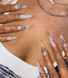 a woman's chest with white and silver nails