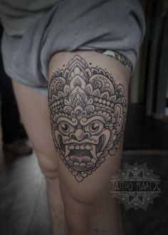 a woman's thigh with a tattoo design on it