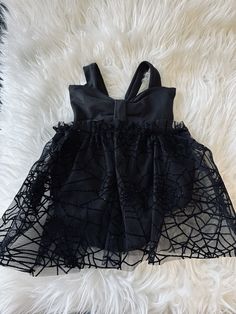 This super cute bow front tool dress. That ties in the back is perfect for the Halloween season. It is made from a DBP fabric, which makes it soft and stretchy. The black tulle has a spiderweb print that is velvet and has silver glitter. Sizing:  Newborn-babies height, 33 inches.  3 months - babies height, 35 inches. 6 months - babies height, 37 inches. 9 months- babies height, 39 inches. 12 months - babies height 41 inches. 18 months - babies height, 43 inches.  2t- babies height, 45 inches. 3t- babies height, 47 inches. Care info:  Please make sure to hand wash and hang dry. This will ensure that the tulle will last longer and not rip. Fitted Tutu Dress With Bow For Party, Tulle Tutu Dress With Bow For Dress-up, Cute Fitted Black Tutu Dress, Cute Black Tutu Dress, Black Fitted Tutu Dress, Cute Style, Black Sleeveless Princess Dress For Dress-up, Holiday Tutu Dress For Costume Party, Fitted Tutu Dress For Halloween Dress-up, Halloween Tulle Dress For Dress-up