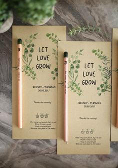 three wedding stationery cards with pencils and greenery on the front one has let love grow written on it