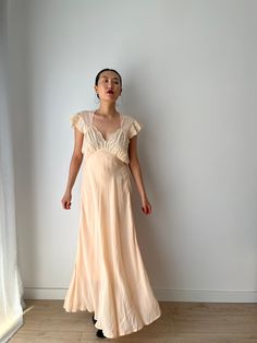 Vintage retro 1930s 1940s lace peach pink bias cut dress material: pure silk chiffon  Size: around M,L,  Model wears size S, 36, 166cm 53kg pit to pit: 46 cm waist:48cm Full length 145cm condition: good antique condition, one tiny small hole on the front bottom of the skirt, not very visible  Please keep in mind that this is almost 100 years old. It may have small marks and/or snags and sign of wear throughout. Please purchase willing to accept all signs of wear. NOTE For shop updates and extra Vintage Apricot Dress For Wedding, Vintage Apricot Wedding Dress, Bias Cut Dress, Cut Dress, Cottagecore Dress, Maxi Gown Dress, Rose Pastel, Silk Gown, Peach Pink