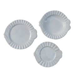 three white plates sitting next to each other