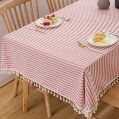 a table topped with plates of food on top of a wooden chair next to a window