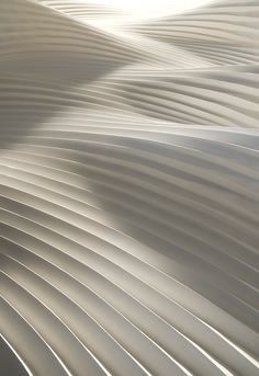 an abstract image of wavy lines in white and grey colors with the sun shining on them