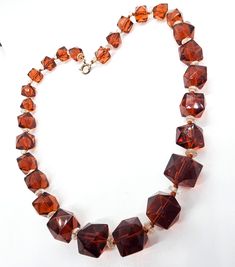 a necklace made with brown glass beads